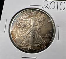 2010 dollar coin clipped planchet error showing curved bite missing from coin edge due to overlapping blank punch during minting